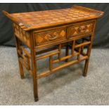 A Reproduction Oriental Style walnut Hall table, carved sleigh-form top above a pair of short