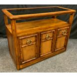 A Contemporary 'Drexel' style, walnut side table/cabinet, rounded rectangular oversailing top with