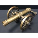 A 1980s brass and anodised metal field gun, brass barrel, spoked wheels, made by Apprentices at