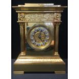 A 20th century brass mantel clock, Roman numerals, flanked by reeded columns, bracket feet. 31cm