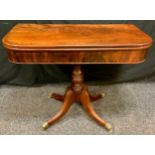 A Regency style Victorian mahogany card table, folding top rounded rectangular top above a turned