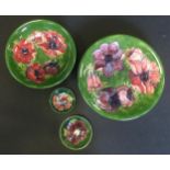 A Moorcroft pottery Anemone pattern circular bowl, similar plate and pin dish; Hibiscus pattern