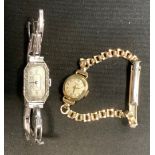 A 1930s platinum and diamond cocktail watch, tonneau silvered dial, Arabic numerals, 15 jewel
