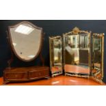 A 20th century, George III style mahogany veneered Toilet Mirror, the shield-shaped mirror on gently