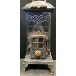 A Victorian cast iron Godin stove, 84cm high, 34cm wide.