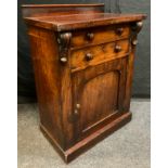 An early Victorian Mahogany side cupboard, having an oversailing rectangular top, above two short