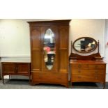 An Edwardian mahogany inlaid wardrobe, outswept cornice above a central bevelled mirrored door and a