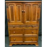 A mis 20th century oak tall boy, pair of linen fold doors over three graduated drawers, Arts &