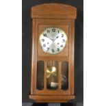 A Junghans oak wall clock, silvered dial, Arabic Numerals, eight day movement, 53.5cm x 26cm