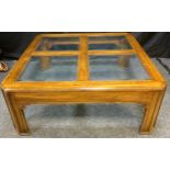 A Drexel'Heritage Furnishings' walnut coffee table, four-pane glass top, 41cm tall x 104cm x 104cm.