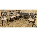 A contemporary wrought iron circular garden table, 72cm high, 91cm diameter; a set of four wrought