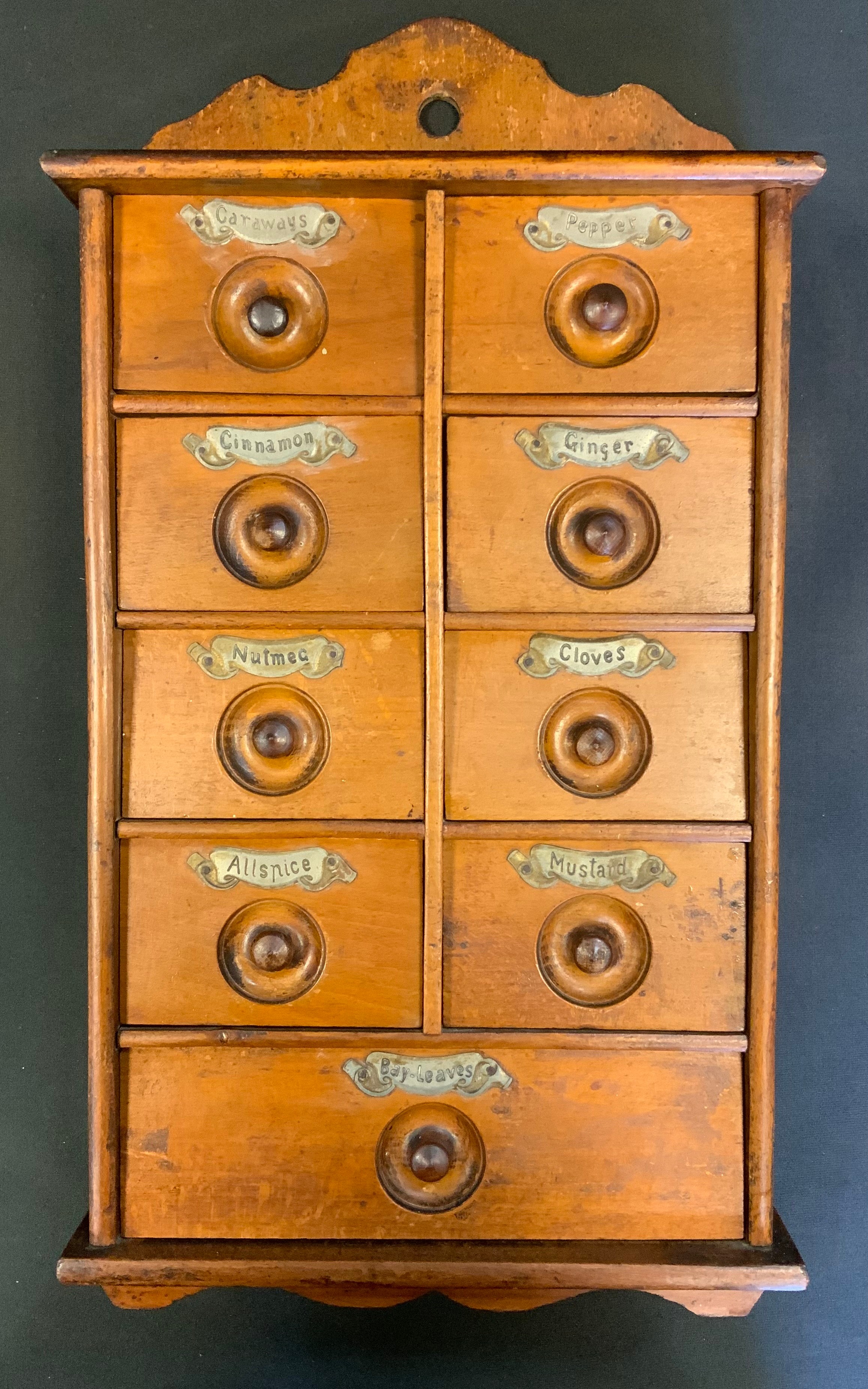 A 19th century oak wall hanging spice rack with an arrangement of drawers.47cm high, 25cm wide.