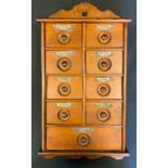 A 19th century oak wall hanging spice rack with an arrangement of drawers.47cm high, 25cm wide.