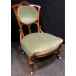 A Victorian mahogany drawing room chair, carved cresting, stuffed over upholstery, bow-front seat,