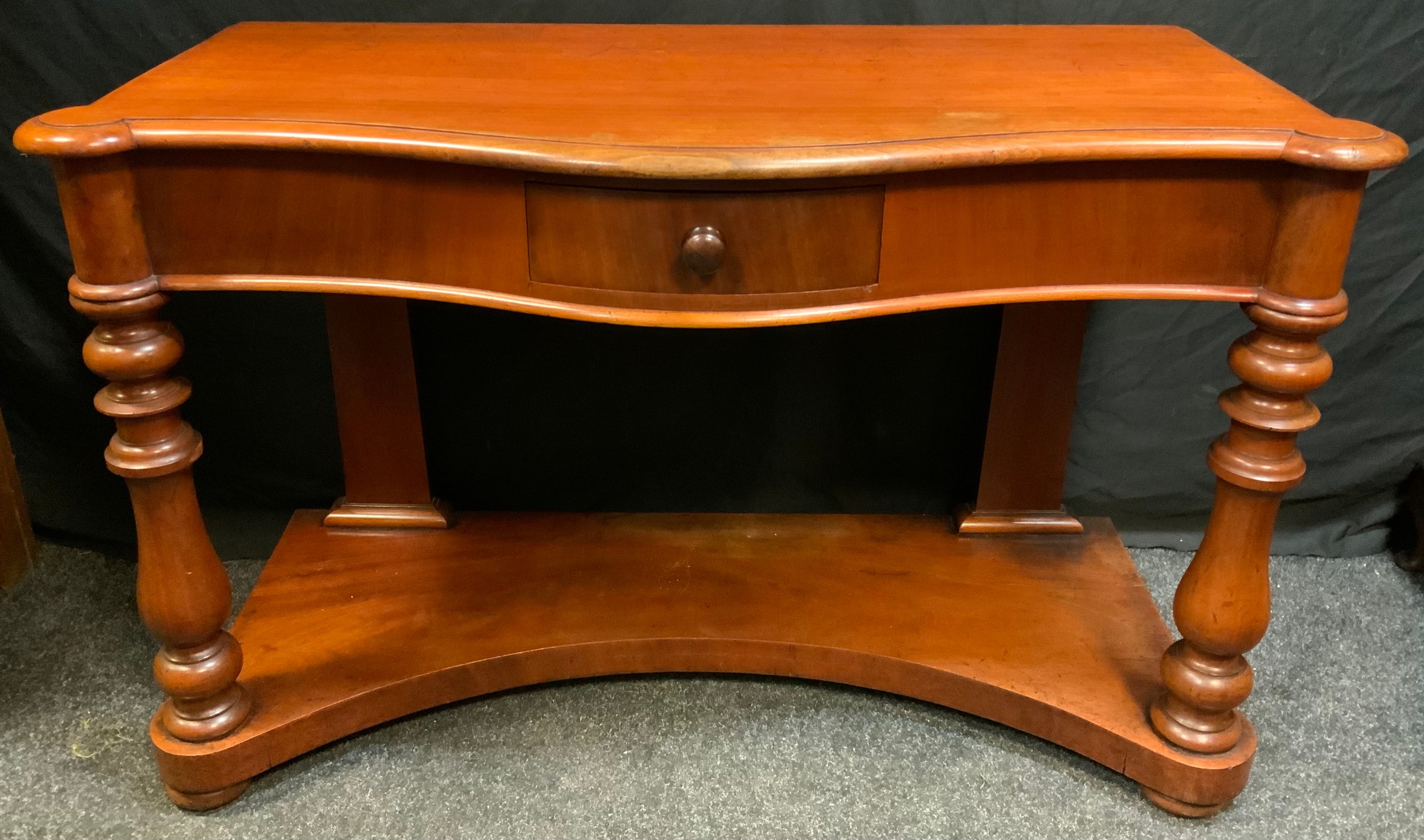 A Victorian Mahogany Serpentine Buffet side-table, single small drawer to front, turned supports,