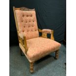 A Victorian mahogany fireside low armchair, carved top rail, button back, turned legs, ceramic