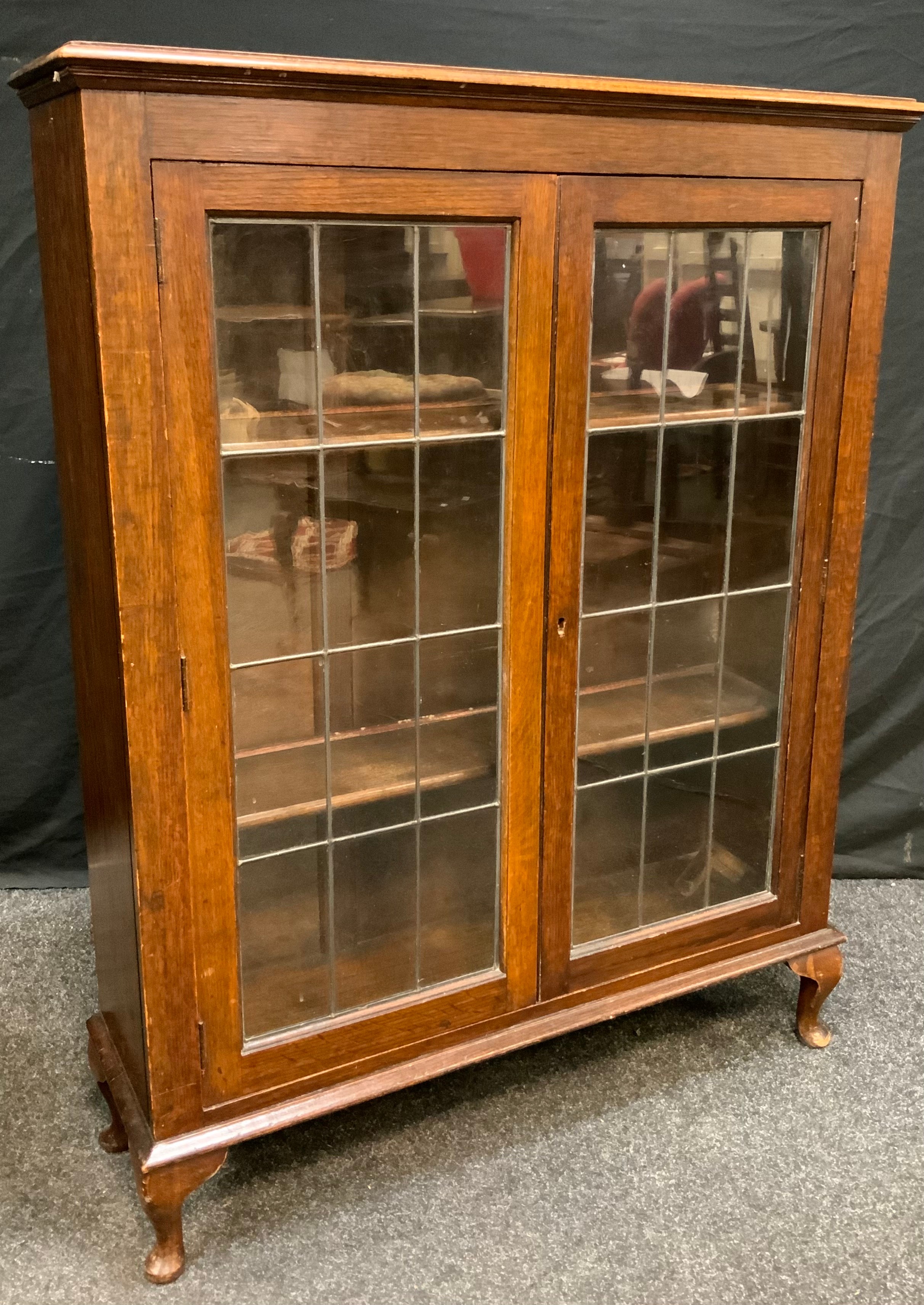 A 20th century oak display cabinet, rectangular top above a pair of astragal cupboard doors