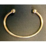 A 9ct gold bangle. 18.5g, boxed