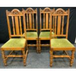 A set of four 20th century oak dining chairs, cresting carved with acanthus, drop-in seats, turned