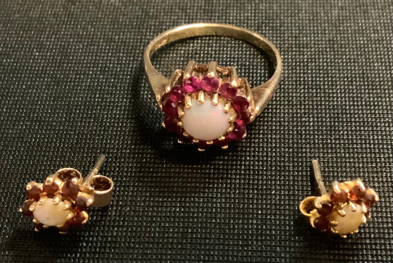 A Ruby and opal floral cluster ring, 9ct gold mount; pair of conforming earrings, 3.3g gross
