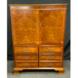 A reproduction walnut television cabinet in the style of a George III chest, rectangular top above a