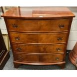 A reproduction teak chest of drawers, bow-front top above four cockbeaded drawers, brass handles,