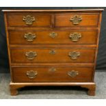 A George III oak chest of drawers, rounded rectangular oversailing top, two short over three long