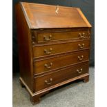 A Late Victorian Mahogany Bureau, fall top enclosing two small drawers and pigeon holes, over four