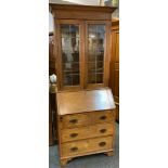 Early 20th century oak bookcase, outswept corners above a pair of astragal cupboard doors, enclosing