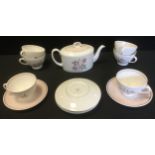 A Susie Cooper bone china tea service, for six, printed with rose spray, washed in pink,