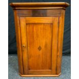A 19th century oak wall hanging splay front corner cupboard, moulded cornice above a rectangular