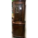 A Reproduction mahogany veneered corner cabinet, dentil cornice, glazed top door, paneled door to