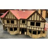 A mid 20th century wooden two storey dolls house, twin bay windowed front, red roof, removable