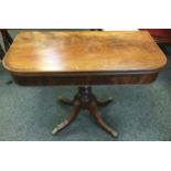 A Regency style Victorian mahogany card table, folding top rounded rectangular top above a turned