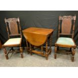 A Pair of Late Victorian Oak Chairs, the tops carved with stylised spiral leaves, bergere back,