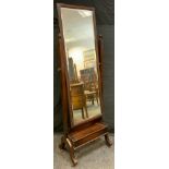 An early 20th century oak floor standing dressing mirror, 170cm tall.
