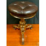 A Victorian mahogany adjustable piano stool, circular leather padded top, tulip turned support,