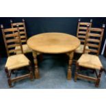 A Rupert Griffith type Arts and Craft style oak dining table, pegged circular top, turned legs, 72cm