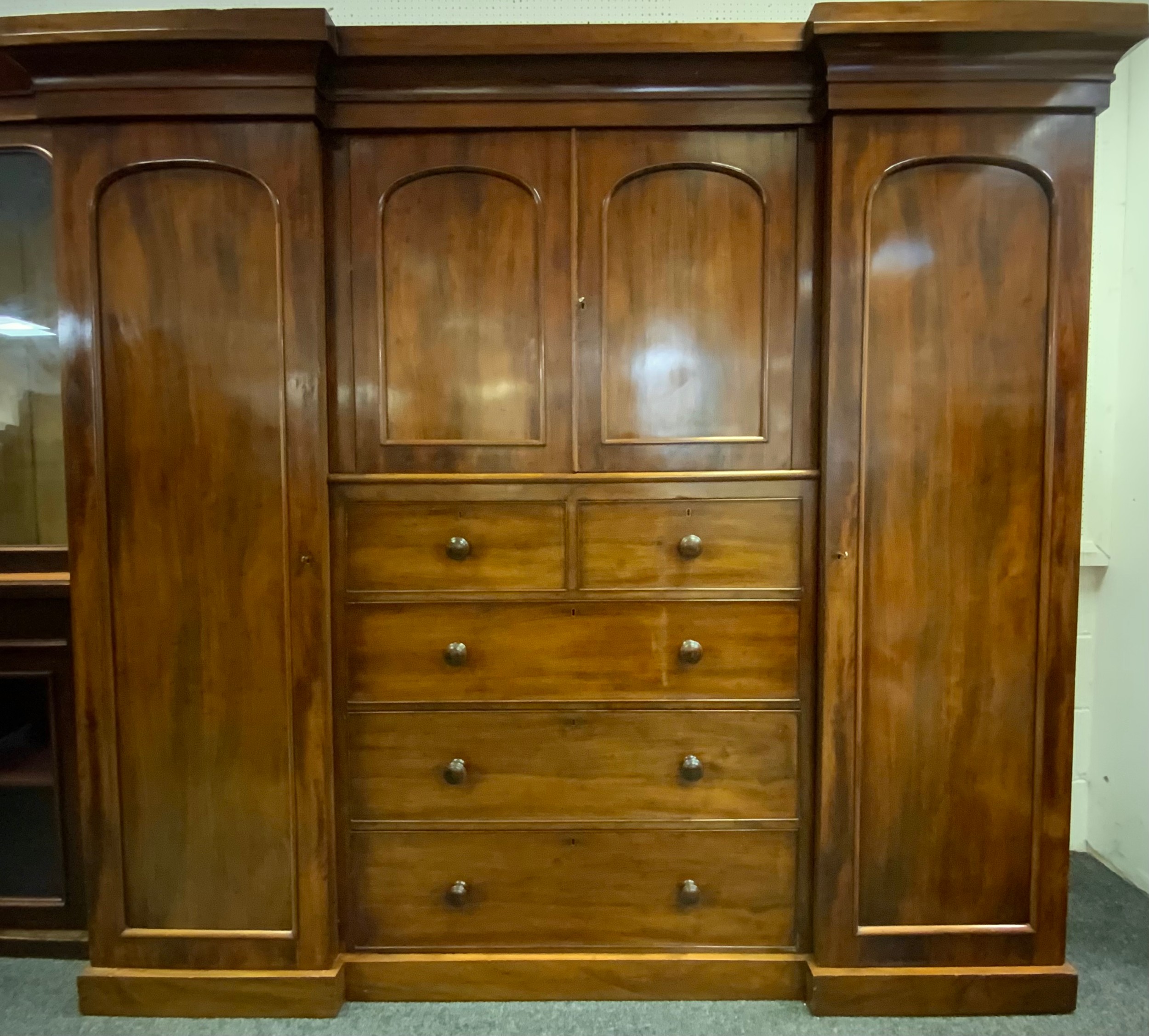 A Victorian Mahogany, Inverted Breakfront Compactum Wardrobe. Having a central two door cupboard,