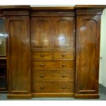 A Victorian Mahogany, Inverted Breakfront Compactum Wardrobe. Having a central two door cupboard,