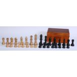 A boxwood and ebonised chess set, stylised pattern, the Kings 11.5cm high