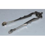 A pair of 19th century Austrian silver tongs, acorn finial, engine turned shoulders, shell nips,