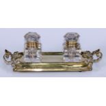 A 19th century gilt-brass partner's inkstand, the rounded rectangular plateau surmounted by a pair