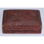 A Chinese cinnabar lacquer rounded rectangular box and cover, in relief with figures in a pagoda