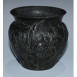 An Art Nouveau pewter ovoid specimen vase, in relief with a sinuous profusion of iris flowers,