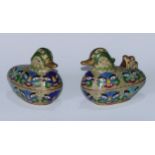 A pair of Chinese cloisonne enamel boxes and covers, as ducks, decorated in polychrome with toatie