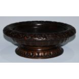 A Neoclassical Revival oak pedestal comport, the fluted saucer-shaped bowl carved in relief with