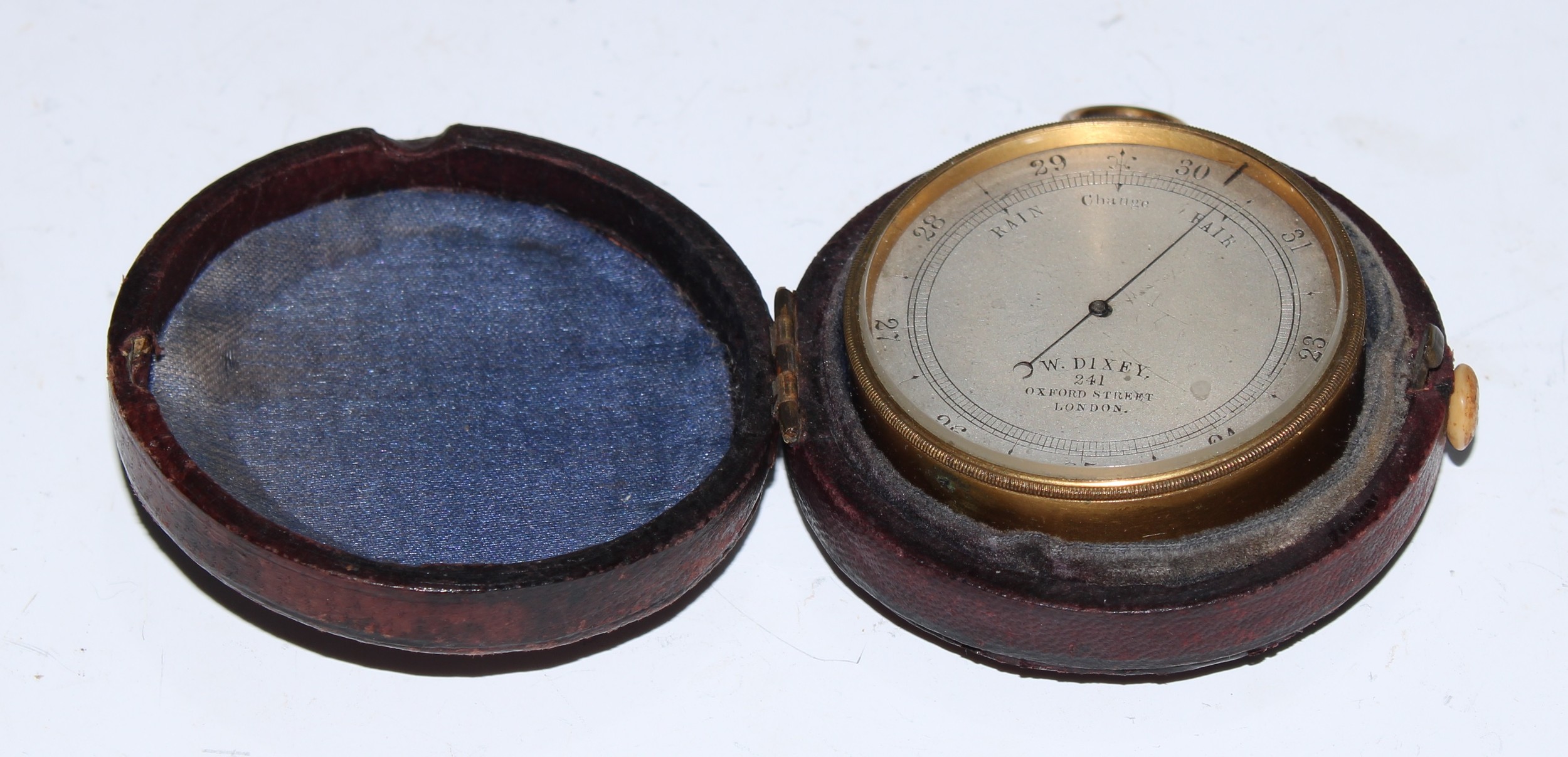 A Victorian gilt brass aneroid pocket barometer, 4.5cm silvered dial inscribed W Dixey, 241 Oxford