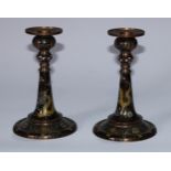 A pair of Chinese cloisonne enamel table candlesticks, decorated in the famille noir palette with