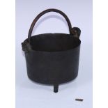 A post-Medieval bronze tripod cauldron, cast with crowned lion masks, wrought iron swing handle,